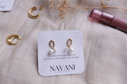 Infinity Pearl Earrings made from stainless steel with a loop design and a pearl accent, showcasing timeless elegance